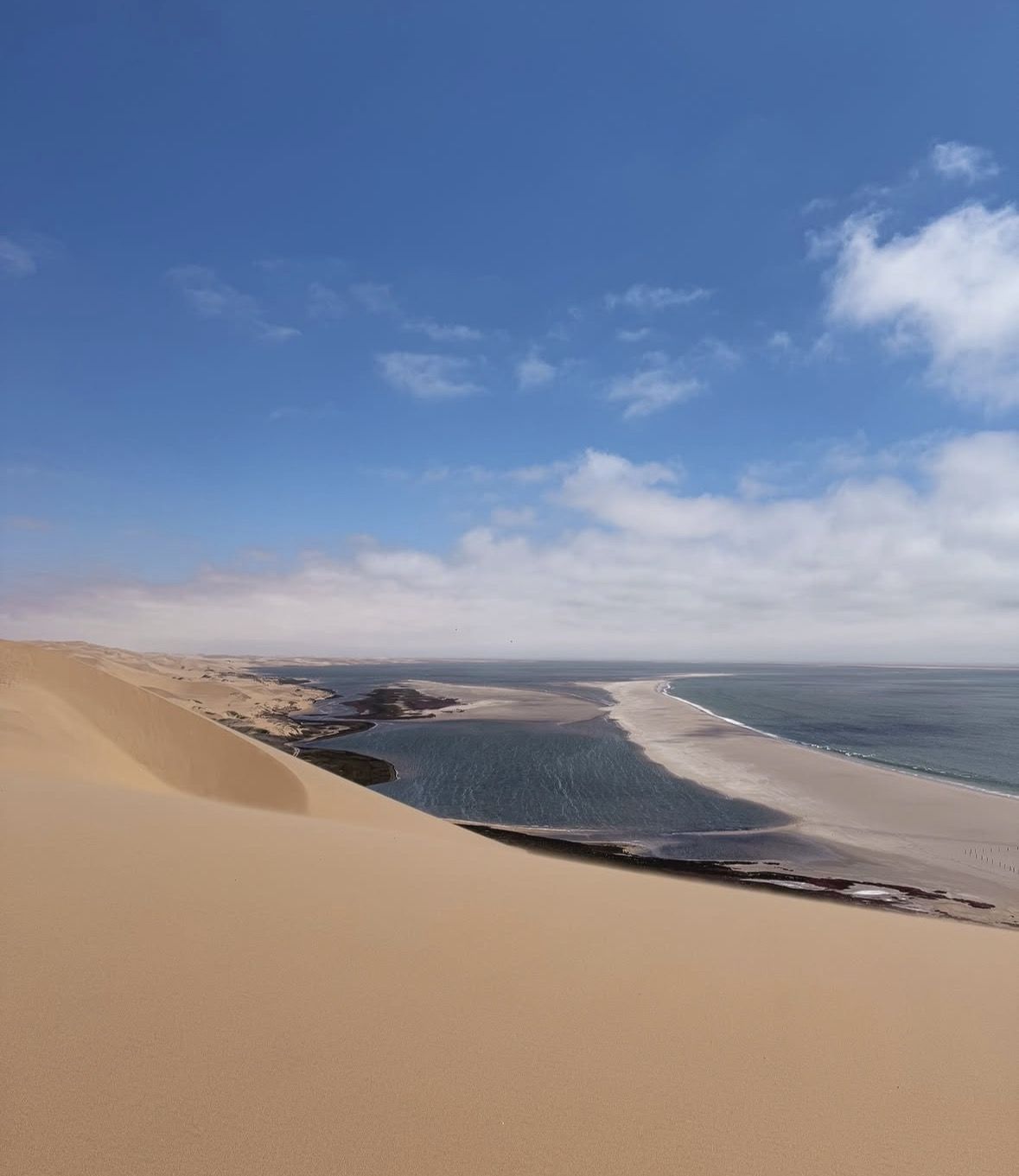 4x4 vehicle crossing tidal flats on the coastal track between Walvis Bay and Sandwich Harbour, Namibia
